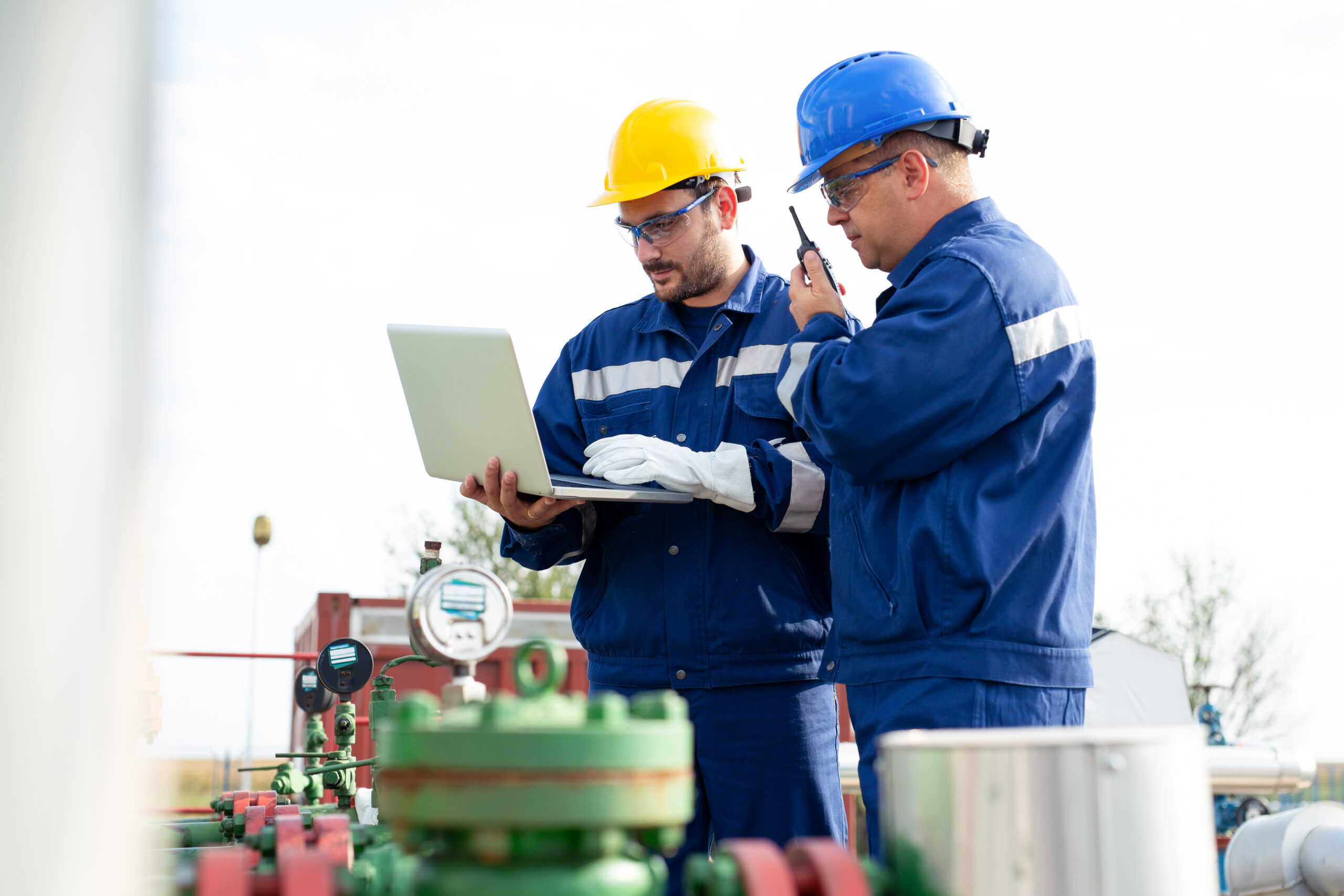 Two workers in the oilfield. Oil and gas concept